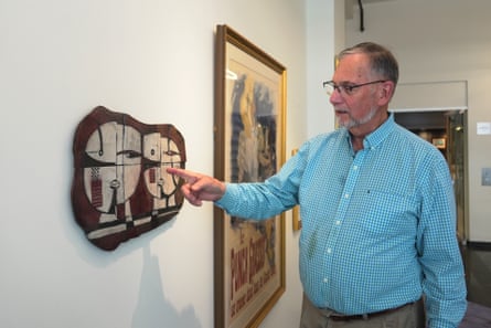 Bill DeLind pointing to where a Pablo Picasso sketch was hanging when it stolen from his shop in 2018.