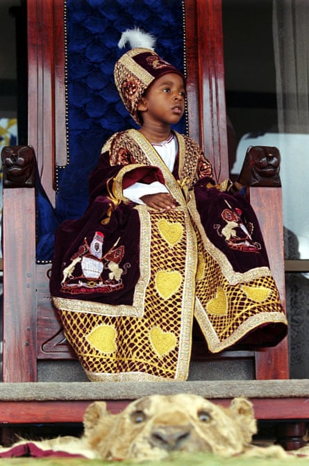 Oyo as a boy in elaborate embroidered robes and crown