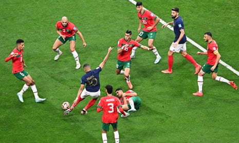 Kylian Mbappé of France takes on the Morocco defence.