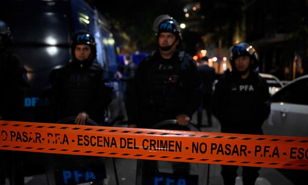 Police stand guard after a man pointed a gun at Argentine Vice-President Cristina Fernandez de Kirchner outside her residence in Buenos Aires