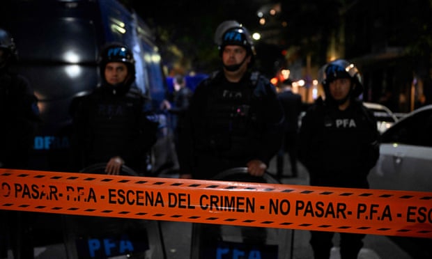 Police stand guard after a man points a gun at Argentine Vice President Cristina Fernandez de Kirchner outside his home in Buenos Aires.