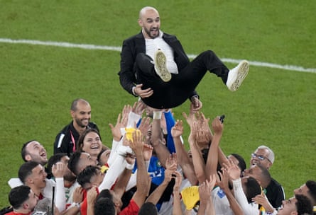 Morocco players celebrate by tossing the head coach Walid Regragui into the air at the end of the World Cup group F soccer match between Canada and Morocco at the Al Thumama Stadium in Doha 1 December