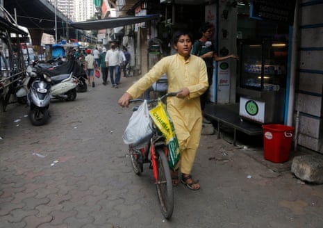 Subhan Shaikh, 14, selling tea from his bicycle in Mumbai.