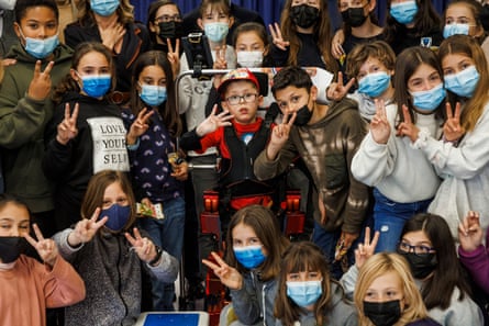 Jorge, who has cerebral palsy, celebrates his 12th birthday at his school surrounded by classmates after crowdfunding allowed him to use a pioneering exoskeleton
