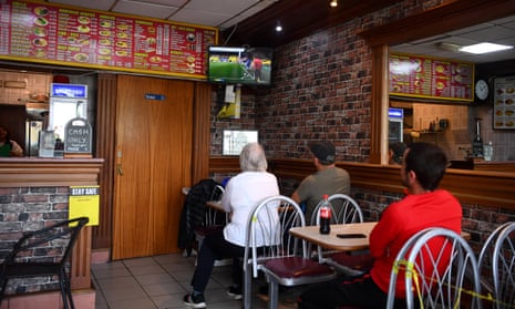 Members of the public watch the game in a cafe near Vicarage Road.