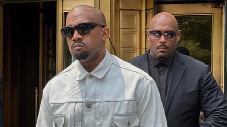Ye, or Kanye West with a security guard