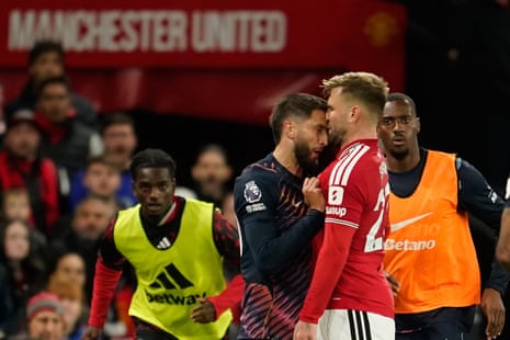 Tottenham's Rodrigo Bentancur (left) clashes with Manchester United's Luke Shaw.