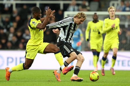 Tottenham's Kevin Danso (left) challenges Nick Woltemade of Newcastle.