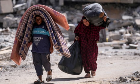 Palestinians follow an Israeli army order to evacuate parts of Khan Younis on Sunday