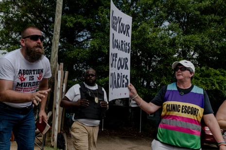 essays over abortion Woman holding a sign in front of a man speaking