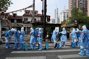 Workers prepare to disinfect a residential compound in Huangpu district