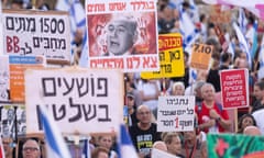 Protesters holding signs protesting Benjamin Netanyahu in Tel Aviv, Israel.