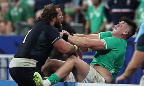 Scotland's loosehead prop Pierre Schoeman (left) shoves Ireland's hooker Dan Sheehan over the advertising hoardings.