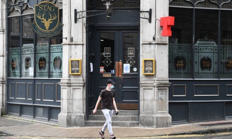 A pedestrian walks past a closed pub in Aberdeen