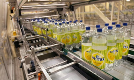 Bottles of R Whites lemonade, made by drinks company Britvic, on a conveyor belt at Britvic's bottling plant