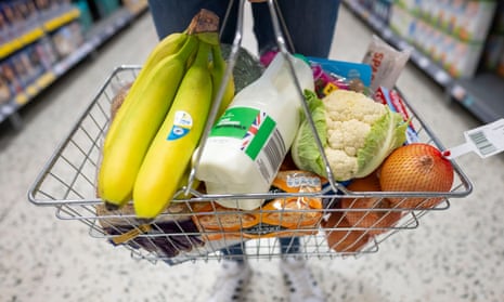  A person holds a basket of goods in a supermarket on May 22, 2022 in Cardiff, Wales.