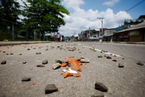Stones are seen on an empty street during a curfew in the town of Rambukkana, Sri Lanka.