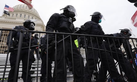 Law enforcement position themselves as a pro-Trump mob gathers outside the US Capitol building on 6 January 2021.