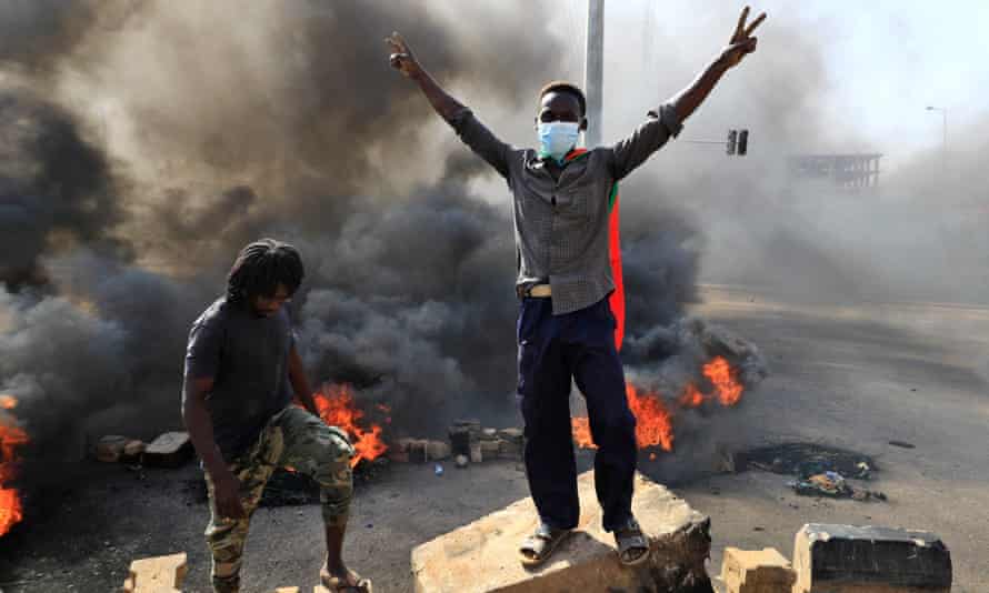 Sudanese protesters burn tyres to block a road in Khartoum