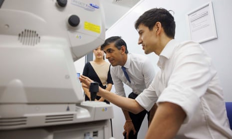 Rishi Sunak is shown a retinal scan procedure by Dr Siegfried Wagner, senior research fellow, during a visit to Moorfields eye hospital in London.
