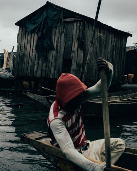 A young man using a canoe in Makoko.