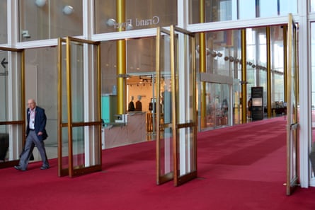 A red-carpeted room with wide-open glass doors.