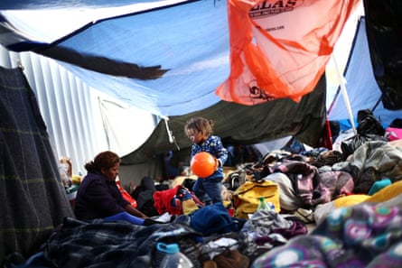 A child holds a ball at a camp near the San Ysidro checkpoint, after US border authorities allowed the first small group of women and children entry from Mexico overnight, in Tijuana, 1 May