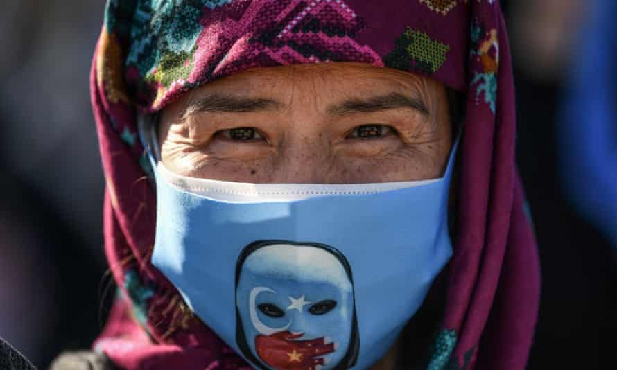 A supporter of China’s Muslim Uighur minority wears a face mask with the flag of East Turkestan during a demonstration by supporters of China’s Muslim Uighur minority in Istanbul