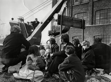 Gypsies and Travellers stand in the path of a digger as the council attempts to evict a site in Canning Town, east London in the 1960s.