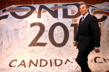 Britain’s then prime minister Tony Blair walks past a large London 2012 banner, as he enters a press conference in a hotel in Singapore in July 2005