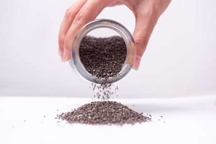 Close up of chia seeds being poured out of a jar.