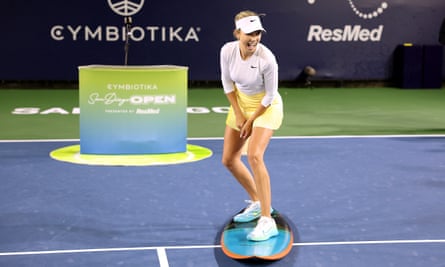 Katie Boulter poses on a surfboard after she defeated Marta Kostyuk in San Diego