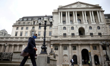 A man walks past the Bank of England