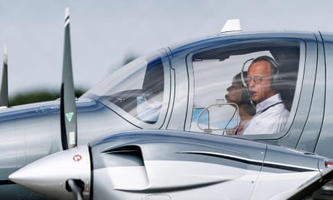 Friedrich Merz sitting in the cockpit of a plane with headphones on