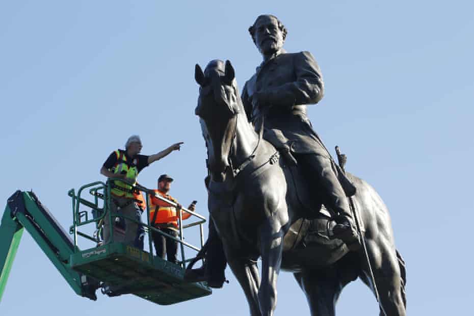 A crew from the Virginia department of general services inspect the statue of the Confederate general Robert E Lee on Monument Avenue in Richmond, Virginia, last year.
