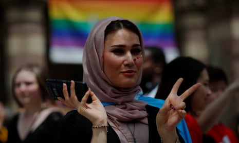Ati, who is a Muslim and transgender, waits for the start of Boston's 48th Pride Parade