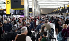 Passengers queue inside the departures area of Terminal 2 at Heathrow airport