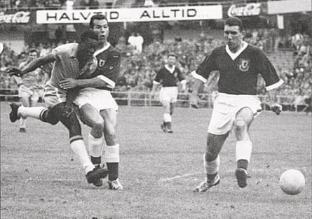 17-year-old Brazilian forward Pele (left) kicks the ball past two Welsh defenders during the World Cup quarter-final match between Brazil and Wales in June 1958. Pele scored the only goal of the match to help Brazil advance to the semi-finals.