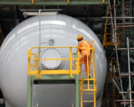 Construction worker stands at newly commissioned Dangote fertiliser plant in Lagos.