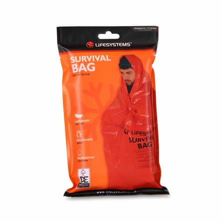 A Decathlon LIFESYSTEMS Survival Bag in its orange packet.