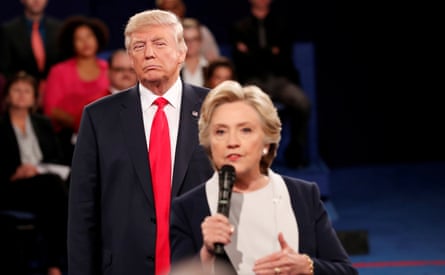 Donald Trump listens as Hillary Clinton answers a question from the audience during their presidential town hall debate in St. Louis, Missouri, in 2016.
