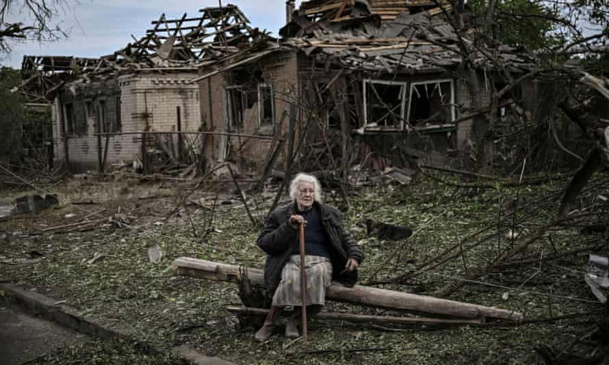 Russia-Ukraine war latest: Putin warns of new targets; Zelenskiy visits troops on eastern front – live | Ukraine 5 An elderly woman sits in front of destroyed houses after a missile strike in the city of Druzhkivka in the eastern Ukrainian region of Donbas.
