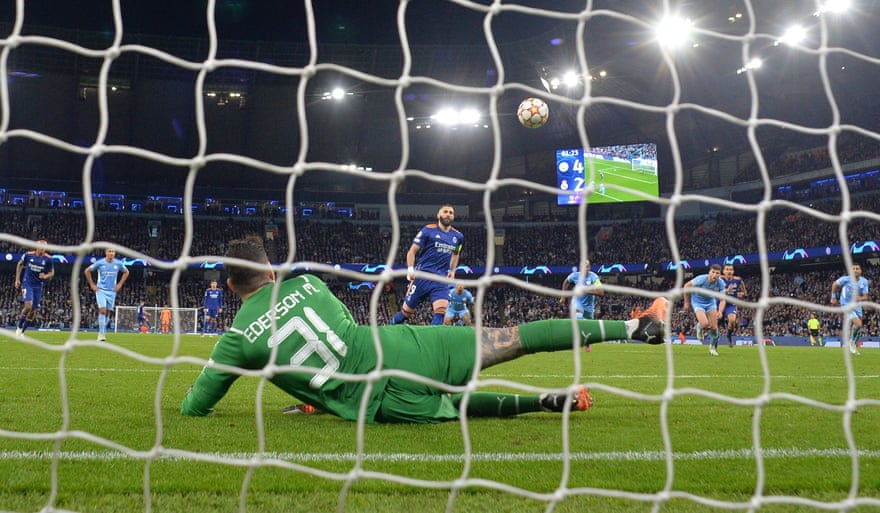 Karim Benzema dinks his Panenka penalty over Manchester City goalkeeper Ederson.