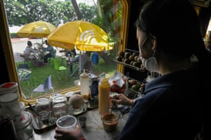 A worker making coffee in a train carriage converted into a cafe at a railway station in Phnom Penh.