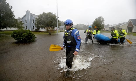 Members of the North Carolina Task Force urban search and rescue team wade through a flooded neighborhood looking for residents who stayed behind as Florence continues to dump heavy rain in Fayetteville, North Carolina