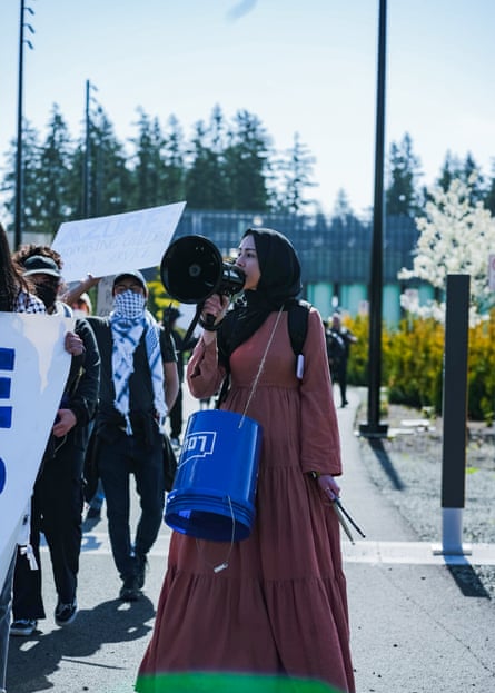 a woman speaks into a megaphone