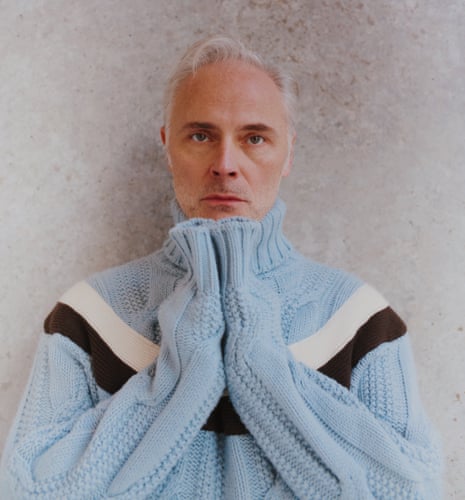 Mark Bonnar wears pale blue cable knit with a ring of dark blue and white