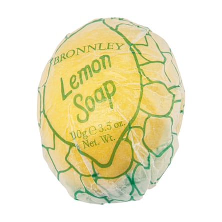 Yellow lemon-shaped soap in transparent paper wrapper
