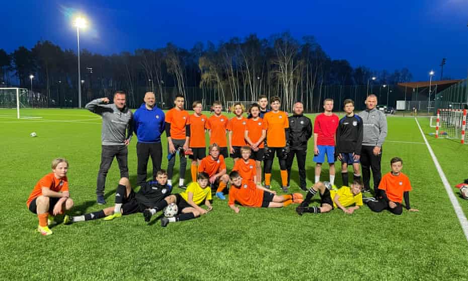 Players from FK Kramatorsk, a professional Ukrainian club, with children from the Turbo Academy in Warsaw.