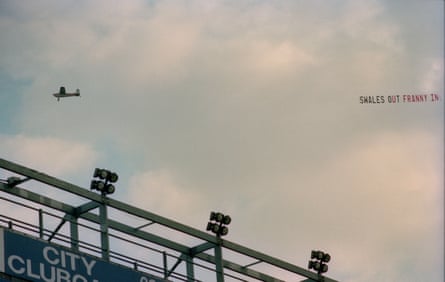 An aeroplane flies over Maine Road during a game v Liverpool with a banner urging for chair Peter Swales to leave and be replaced by Francis Lee, October 1993.